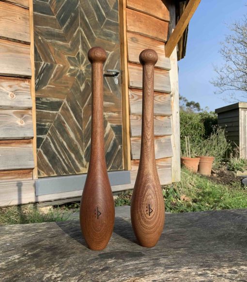 Pair-Of-Small-Wooden-Indian-Clubs-In-Garden