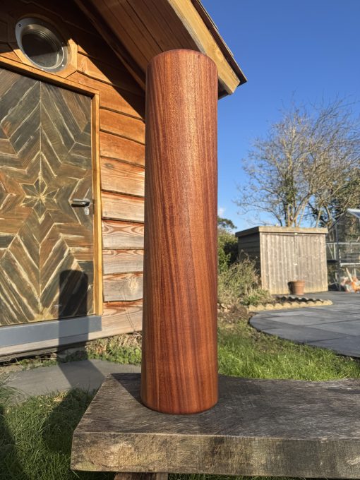 Rear side of a 14kg wooden sumtola in a garden